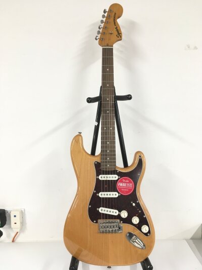 A Fender Squier Stratocaster electric guitar. Comes with soft carry case.