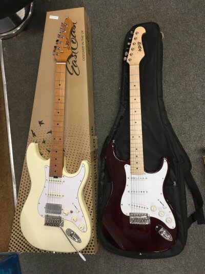 Two Stratocaster style electric guitars comprising an Eastcoast example with original retail box plus an Indio Classic example with soft carry case.