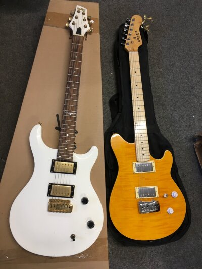 Two electric guitars comprising a Vintage model with non original retail box and a Cozart guitar with soft carry case.
