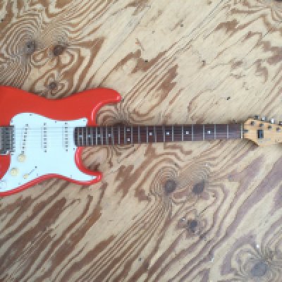 A Japanese Fender Squier Stratocaster electric guitar. Some repairs to the body and alteration to the tuners. No case.