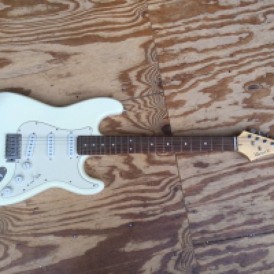 A Wesley Stratocaster style electric guitar and a Wesley bass guitar. Both with soft carry cases.