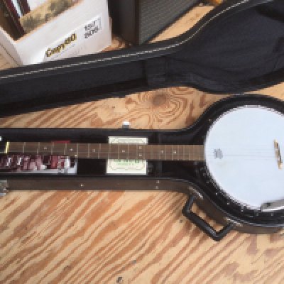 A cased Ozark banjo. Has been altered so it is now open backed but the original back cover is included.