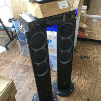 A pair of Linn floorstanding speakers and a box of audio visual equipment.