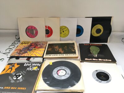 A collection of 7" singles and EPs by various artists including Paul Weller, U2, Link Wray and others.