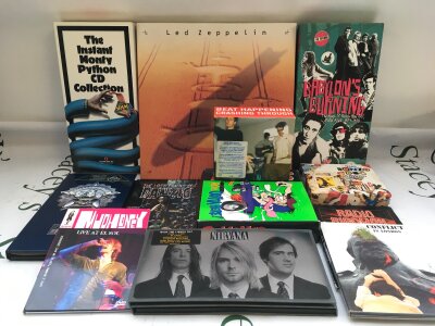 A collection of CD box sets by various artists including Nirvana, Ramones, Led Zeppelin and others.