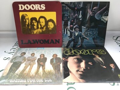 Four early UK pressings of LPs by The Doors comprising the debut album, Strange Days, Waiting For The Sun and LA Woman.