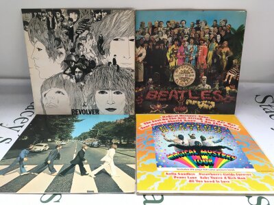 Four Beatles LPs comprising Revolver, Sgt Pepper, Abbey Road and Magical Mystery Tour.
