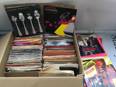 A box of 7" singles by various artists from the 1960s onwards.