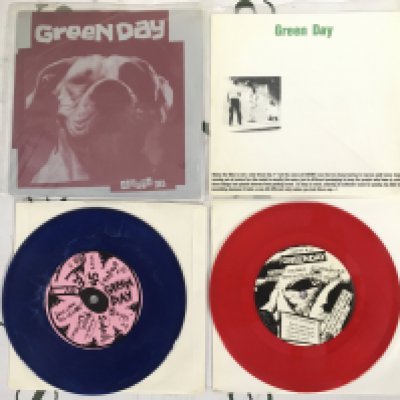 Two coloured vinyl Green Day EPs comprising a first US pressing of the Slappy EP on blue marbled vinyl plus a pink vinyl pressing of Sweet Children. Both EX/EX.