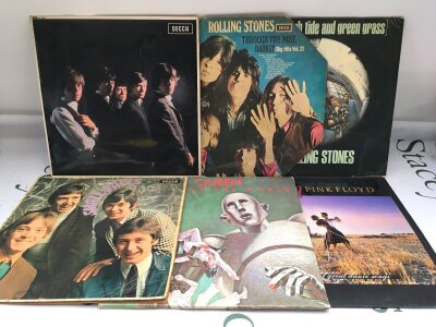 Twelve rock and pop LPs by various artists including The Rolling Stones, Queen, Pink Floyd and others.