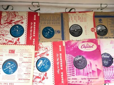 A box of 78s comprising various rock n roll, doo wop, skiffle and jazz titles. Artists include Gene Vincent, Elvis Presley, Larry Williams and many more plus a Hank Taylor test pressing.