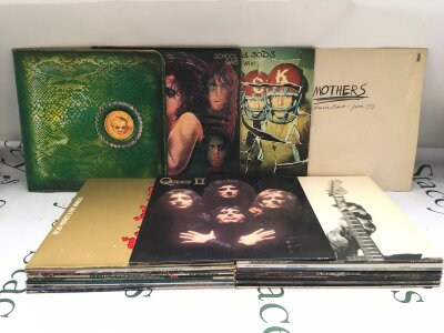 Two bags containing 26 LPs by various artists including Alice Cooper, Queen and others.