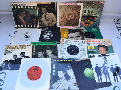 A box of 7" singles and EPs by various artists including The Beatles, Jimi Hendrix, King Crimson and many more.