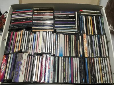 A box of CDs by various artists including Amy Winehouse, Madonna, George Michael and many more.