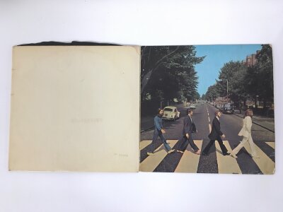 A numbered Beatles White Album (no inserts) 0044824 plus an early pressing of Abbey Road (2).  Some scratches.