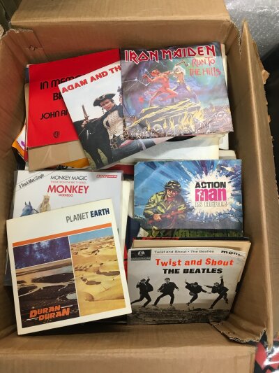A large box of 7" singles and EPs by various artists including The Beatles, Iron Maiden, Sparks and many more.