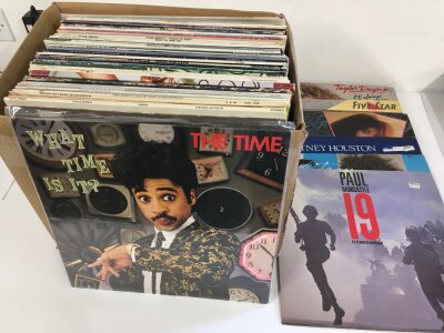 A box of LPs and 12" singles by various artists including Prince, George Benson, Chic and others.