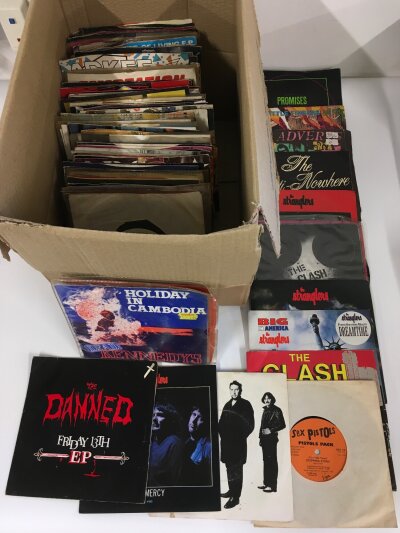 A record case and a box of 7" singles including many punk titles.