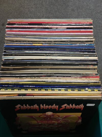 A box of LPs by various artists including Black Sabbath, Genesis, Bruce Springsteen and others.