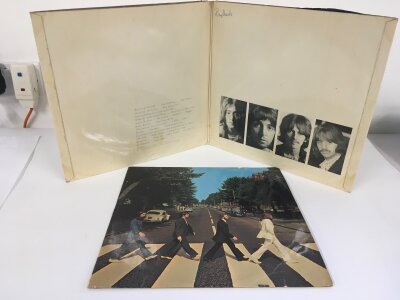 A numbered Beatles White Album with poster but missing portraits, 0050017 and an early UK pressing of Abbey Road with YEX 749 -2/ YEX 750 -2 matrices. Both records are VG+ but Abbey Road needs a clean and both have writing on labels, both sleeves showing signs of age/wear.