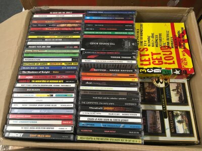 Two boxes of CDs by various artists including Gwar, The Dickies, Bad Religion and many more plus a Sex Pistols CD long box set and a box of VHS tapes of various bands including NOFX, Black Flag, PiL and others.