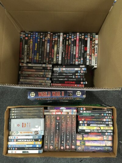 A large collection of DVDs and VHS cassettes.