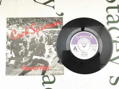 A promo 7" disc for Runnin Riot by Cock Sparrer. Vinyl EX.