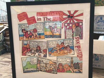 A framed and glazed reproduction Sex Pistols poster for the Holidays In The Sun single, approx 79cm x 79cm.