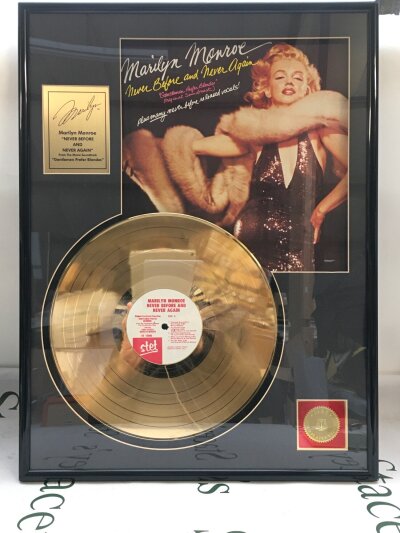 A framed and glazed Marilyn Monroe Never Before And Never Again gold disc with COA.
