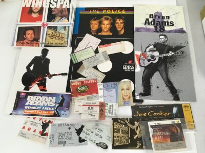 A collection of concert programs and tickets for various artists including Bryan Adams, Cher, The Police and others.
