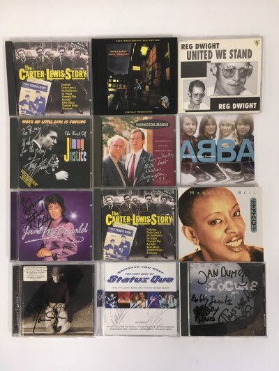 A small collection of CDs, mostly signed, comprising Status Quo, Focus, James Taylor and others. Please note ABBA,Elton John and David Bowie CDs are not signed.