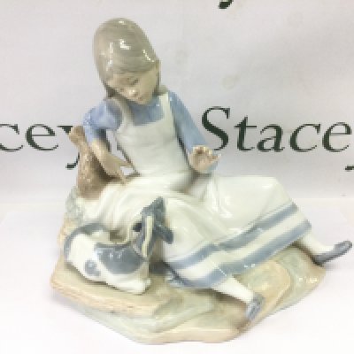 A Lladro figural group of a girl with a goat at her side, approx height 24cm. Shipping category D.