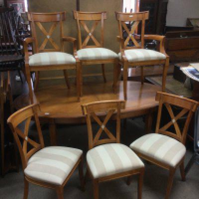 A bespoke cherry wood extending dining table with two carvers and four chairs.Approx 185cm x 105cm when closed. Shipping category D.