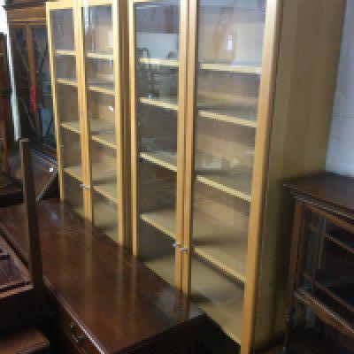 Two light wood display cabinets, approx height 202cm. Shipping category D.