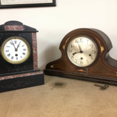 Two mantle clocks- mahogany inlaid clock with German movement (26cm tall 45cm wide) and a slate and marble clock (29cm tall 23cm wide). This lot cannot be posted. NO RESERVE