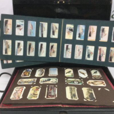 A tin containing a collection of cigarette cards, loose and in albums. Shipping category D.