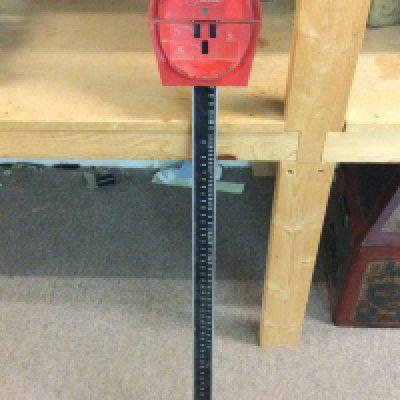 A vintage garage belt measure made by Gates, 98cm tall