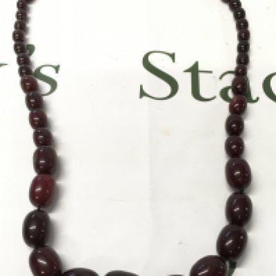 A large cherry amber bakelite necklace , 140g total weight, 98cm long. Postage category A