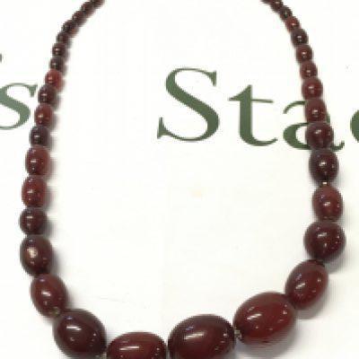 A cherry amber bakelite necklace , 80cm long. 95g total weight approximately . postage category A