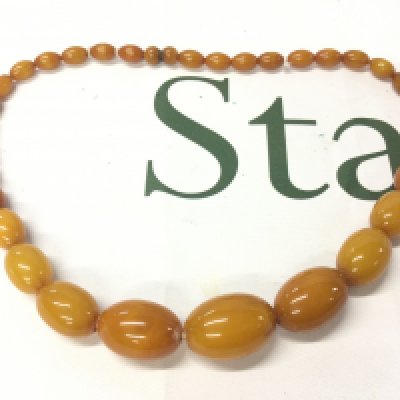 A Bakelite amber necklace , 48cm long. 46g total weight. Postage category A