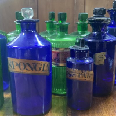 A collection of 19th Century Bristol Blue and Green glass apothecary bottles. 14/20/21cm (D) some damage., partial labels