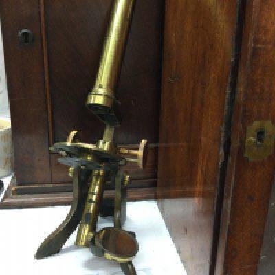 A cased brass Monocular together with a mahogany cabinet fitted with numerous specimen slides one other brass Monocular and a smaller case of slides.