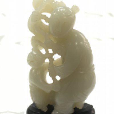 A Chinese jade figure group with stand, figure approximately 8cm tall. No obvious damage or restoration.Postage category A