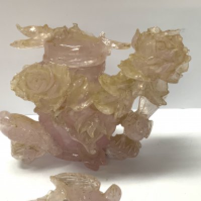 A carved Rose Quartz carved lidded pot with rose and bird decoration. (A/F)