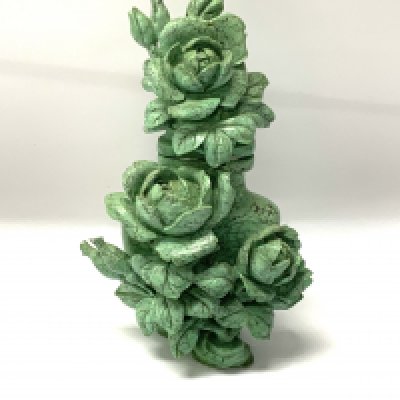 A small turquoise lidded vase with intricately carved rose bush decoration. 11cm.