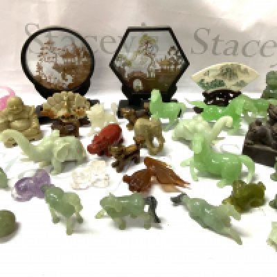 A large collection of carved jadeite and soapstone figures.