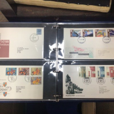 A box containing well presented albums of first day covers.