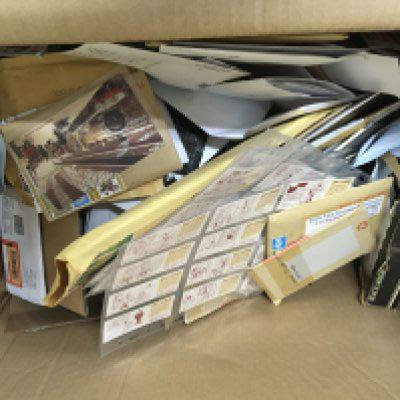 A box containing a large quantity of unopened postage envelopes containing numerous unsorted mixed Vintage cigarette cards and vintage postcards.