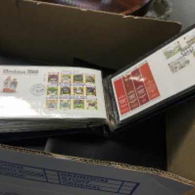 A box containing numerous albums of First day postal Covers.
