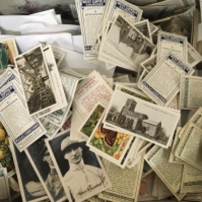 A box containing a large quantity of mixed loose cigarette cards.